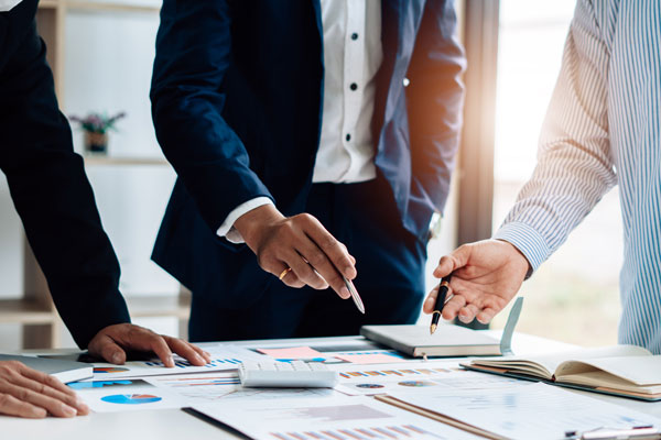 professionals strategically planning, conducting analysis, and doing vendor research